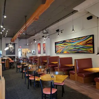 View inside SamB's restaurant with chairs and artwork.