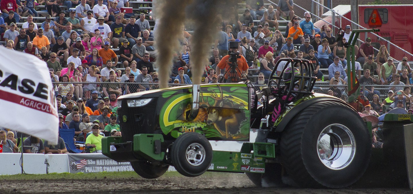 Family walking next to a mural wall with artwork on it.